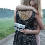 two women giving and sharing